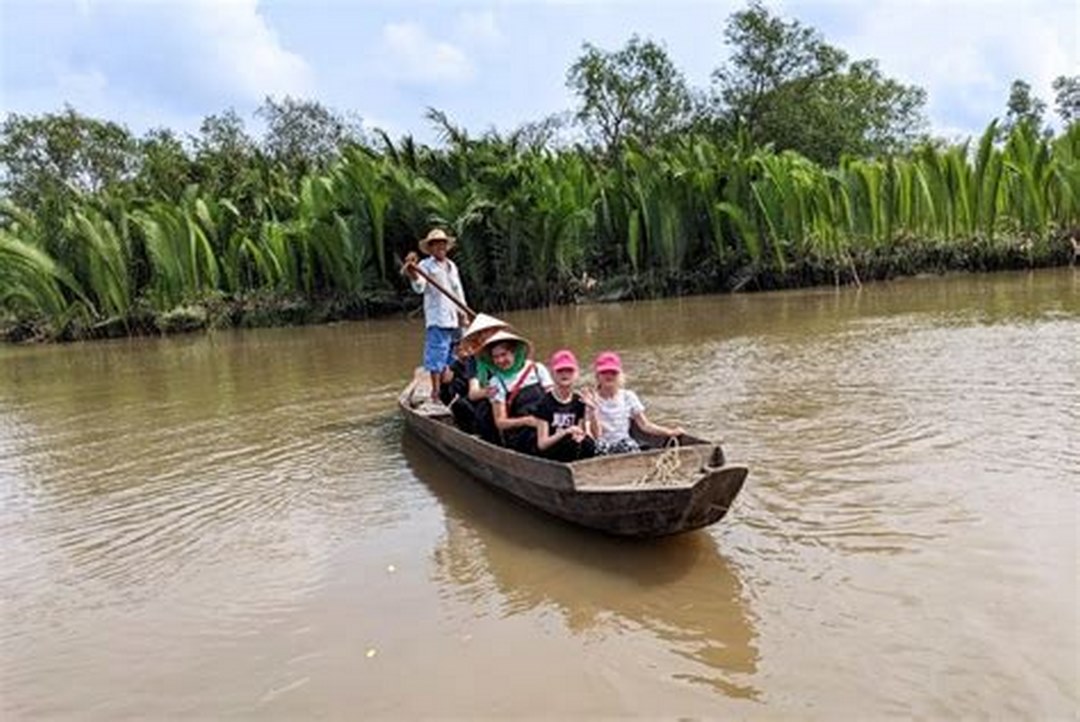 A sampan gliding through Mekong Delta waterways