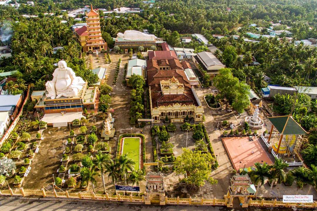 Aerial view of Vinh Trang Pagoda in My Tho - the ornate main hall, smiling Buddha, and reclining Buddha set amid lush gardens
