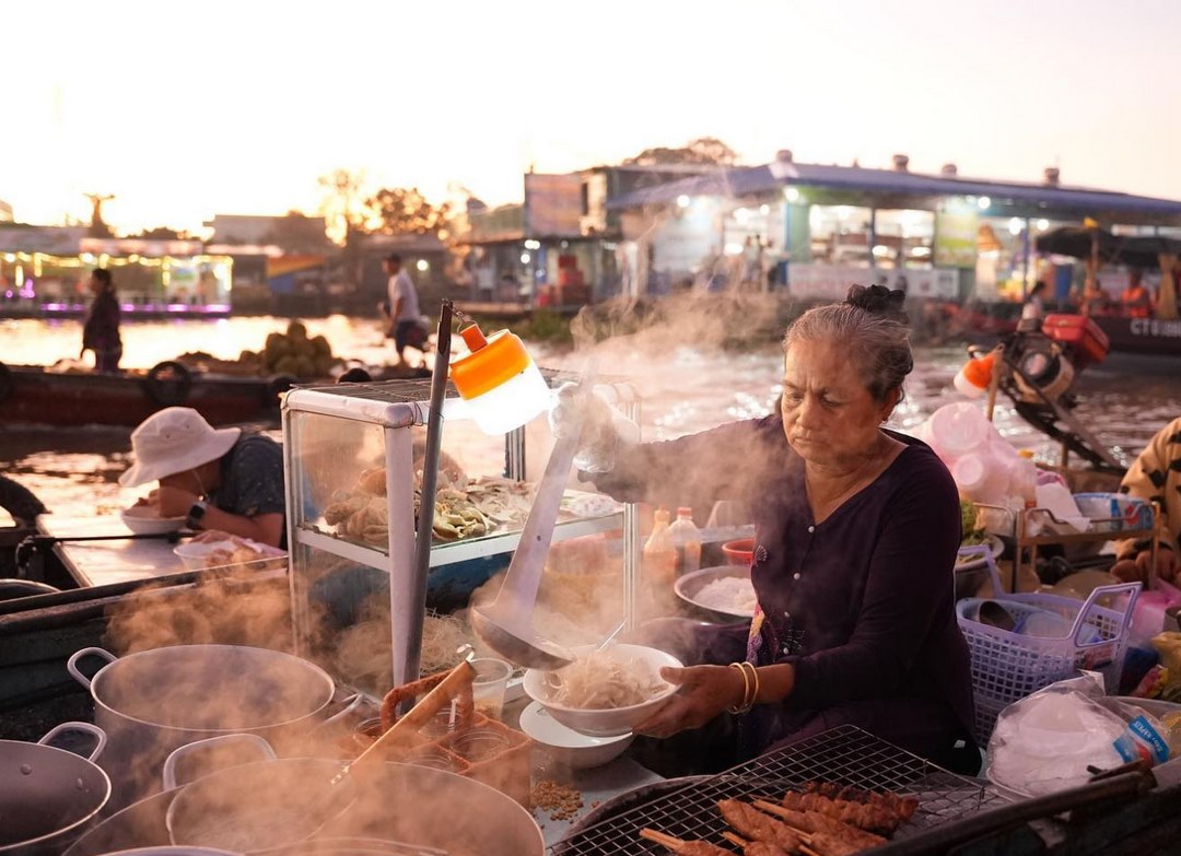 Breakfast boat at the market — coffee and noodle soup served on the water