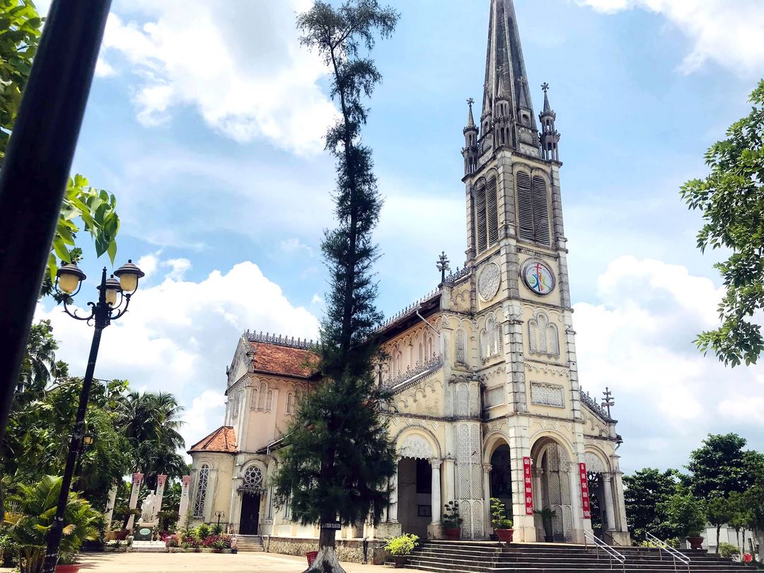Cái Bè Church’s tall neo-Gothic bell tower rising above the riverside town