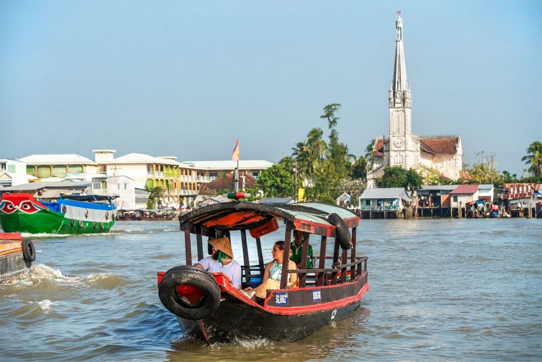Colorful river boats gathering in Cai Be floating market during morning tour