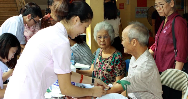 Community clinic staff assisting seniors in Vietnam - reflecting both cultural values and modern approaches in Mekong Vietnamese aged care