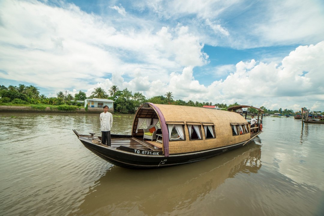 Covered sampan cruising the Mekong Delta