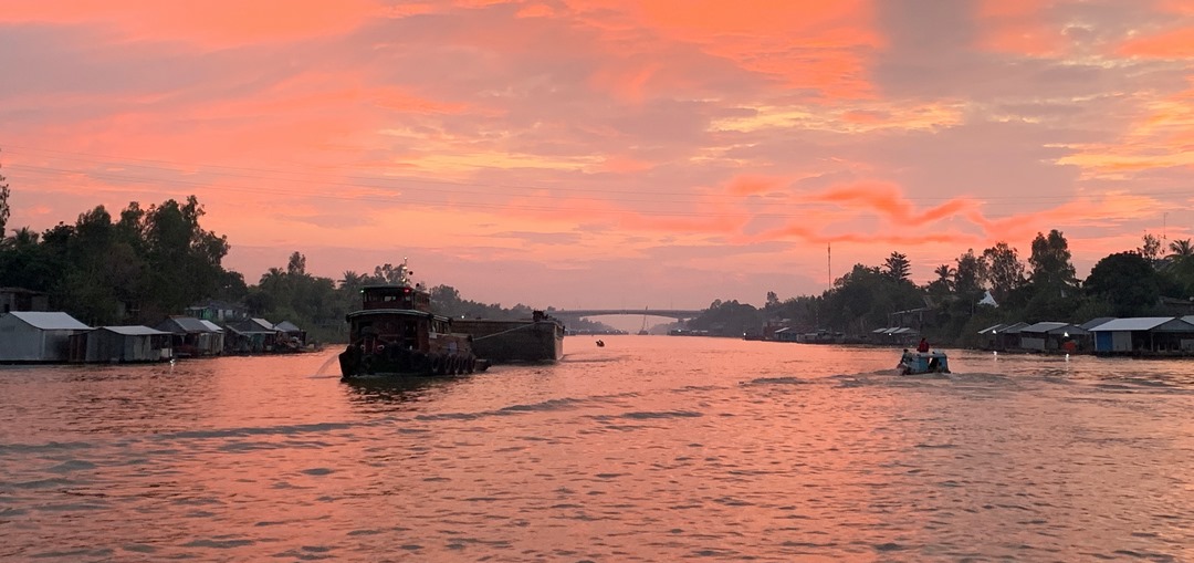 Golden sunset over the Mekong River near Cai Be — a peaceful moment to reflect on your travel choice