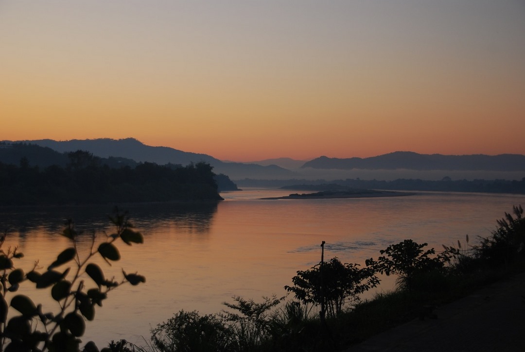 Soft dawn light and calm waters on the Mekong in the early morning
