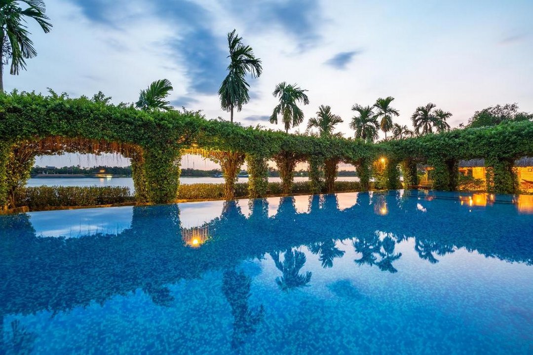Swimming pool framed by tropical foliage and palm trees—one of the standout facilities of the lodge