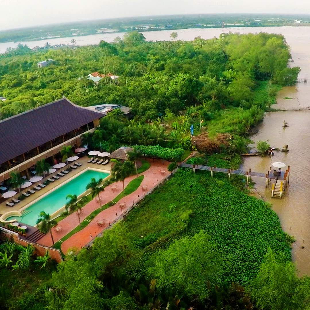 The Island Lodge nestled on a tranquil islet, surrounded by lush greenery and waterways - a serene riverside retreat in the Mekong Delta