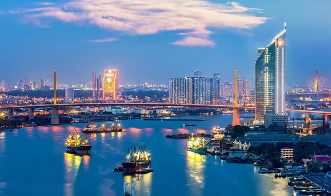 The city lights reflected over the Hau River at night, showcasing the lively waterfront of Can Tho