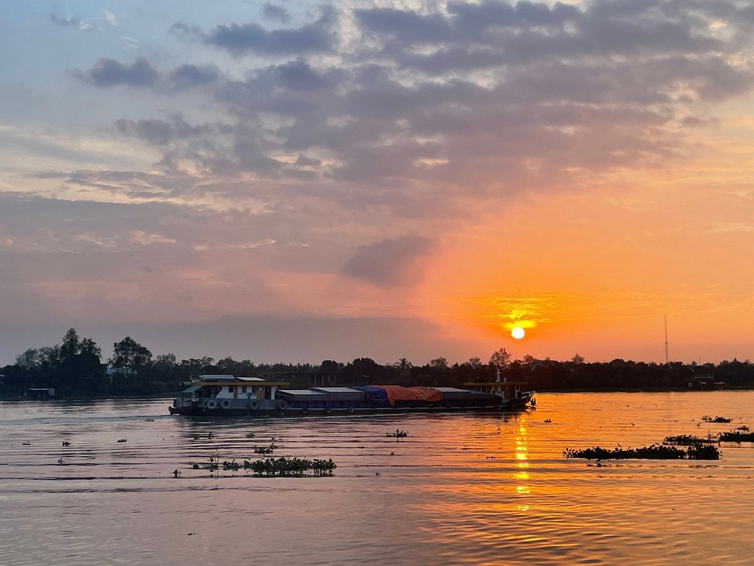 Tranquil river scene at dusk, boats drifting gently — inviting you to unwind and reflect