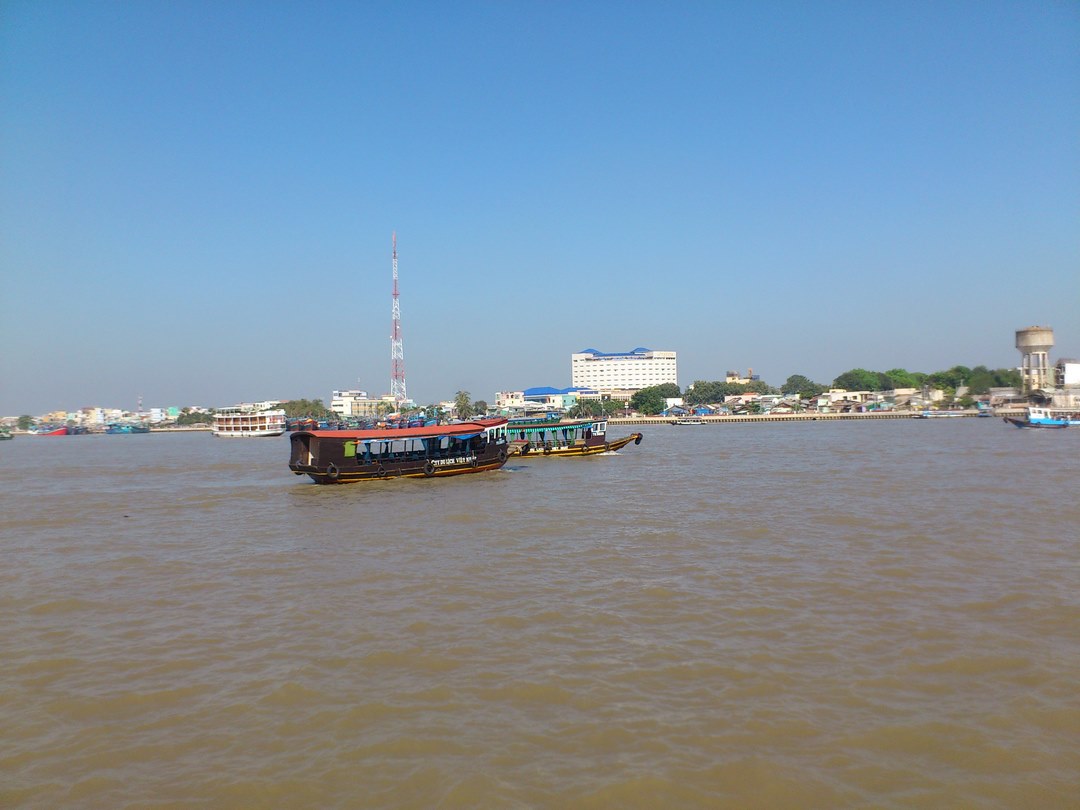 Wide view of the Tien River flowing past My Tho — where the motorboat leg of the trip begins