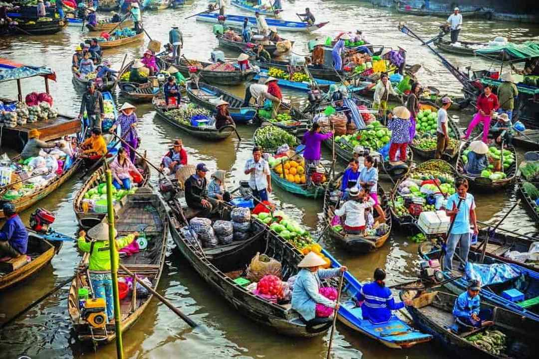 Mekong Delta what to see: Boats piled high with fresh produce at Cai Rang Floating Market, Can Tho, Vietnam