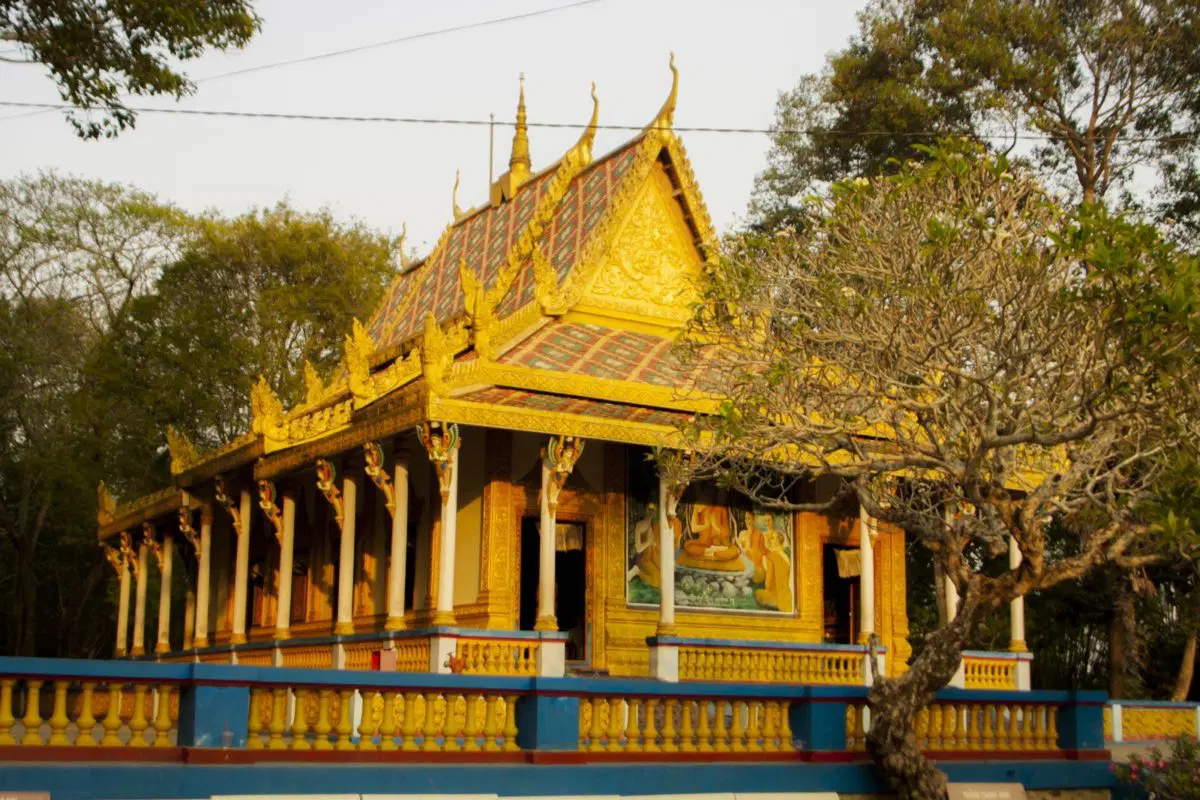 Entrance gate of the Bat Pagoda with intricate decorative details under morning light
